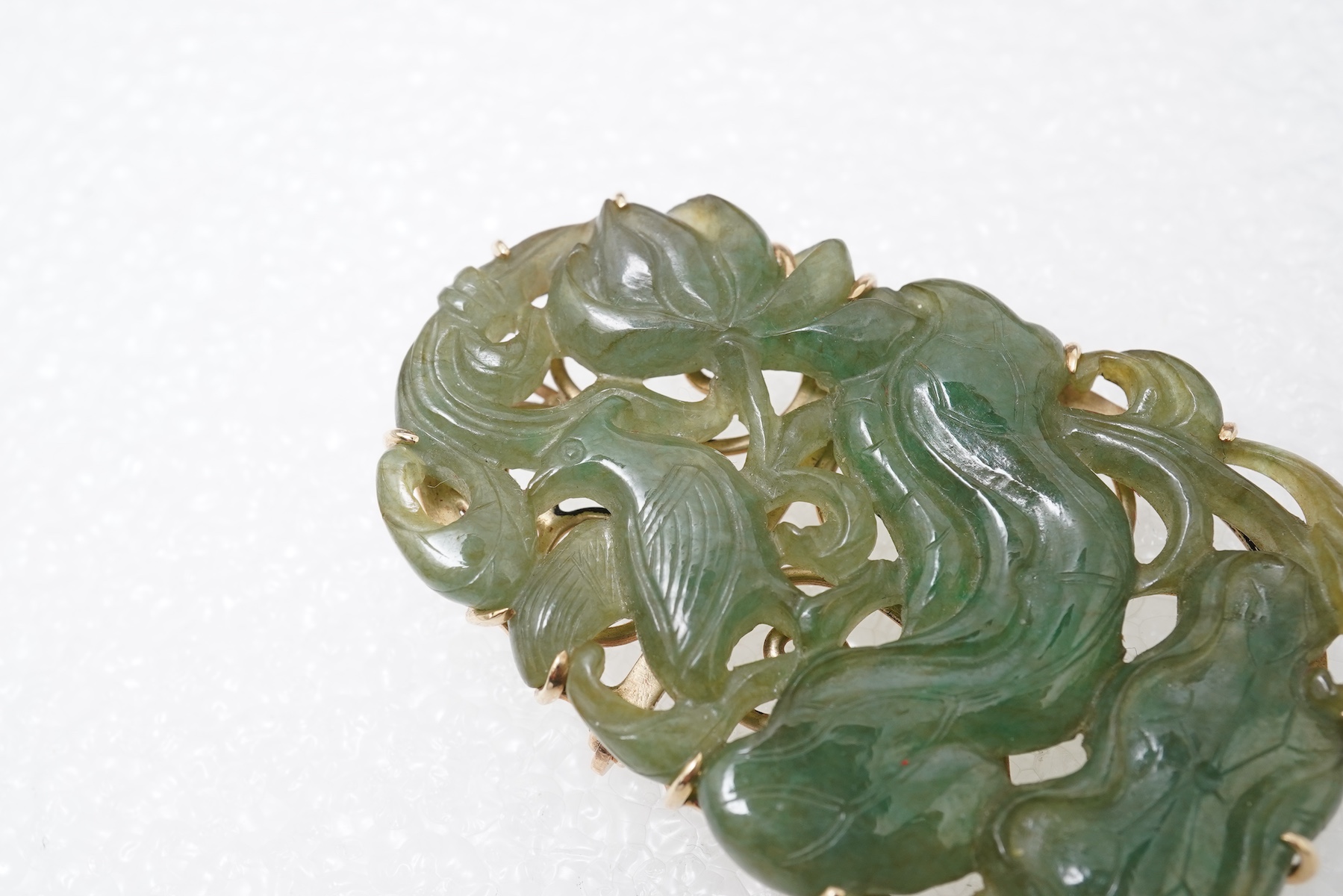 A carved jadeite brooch/pendant